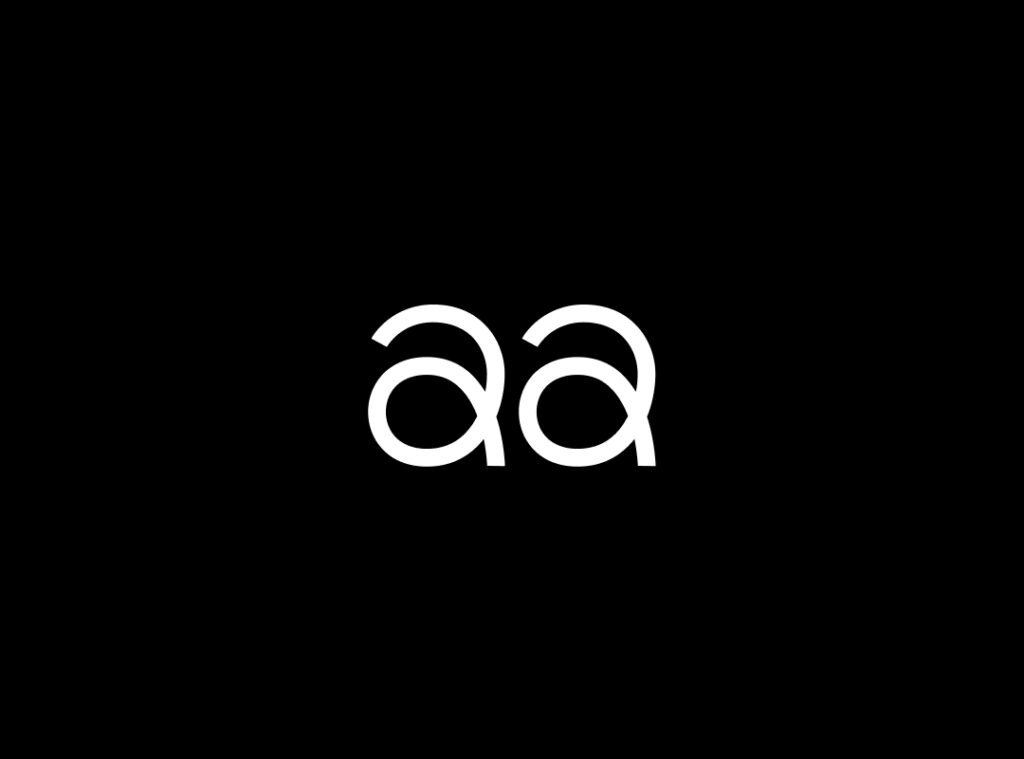 A close-up of the letters "Aa" in the Slinkee typeface, a playful and bouncy font, in a white color on a black background.