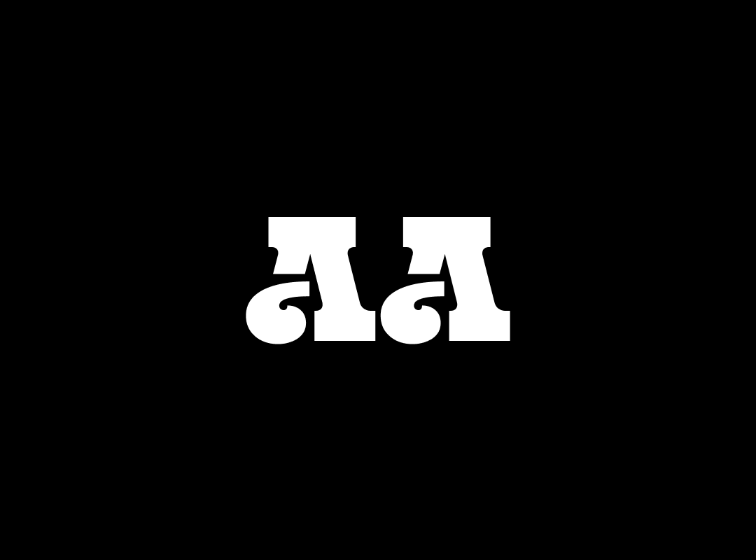 A close-up of the letters "Aa" in the Exile font, a bold, all-caps display stencil font with sharp serifs.