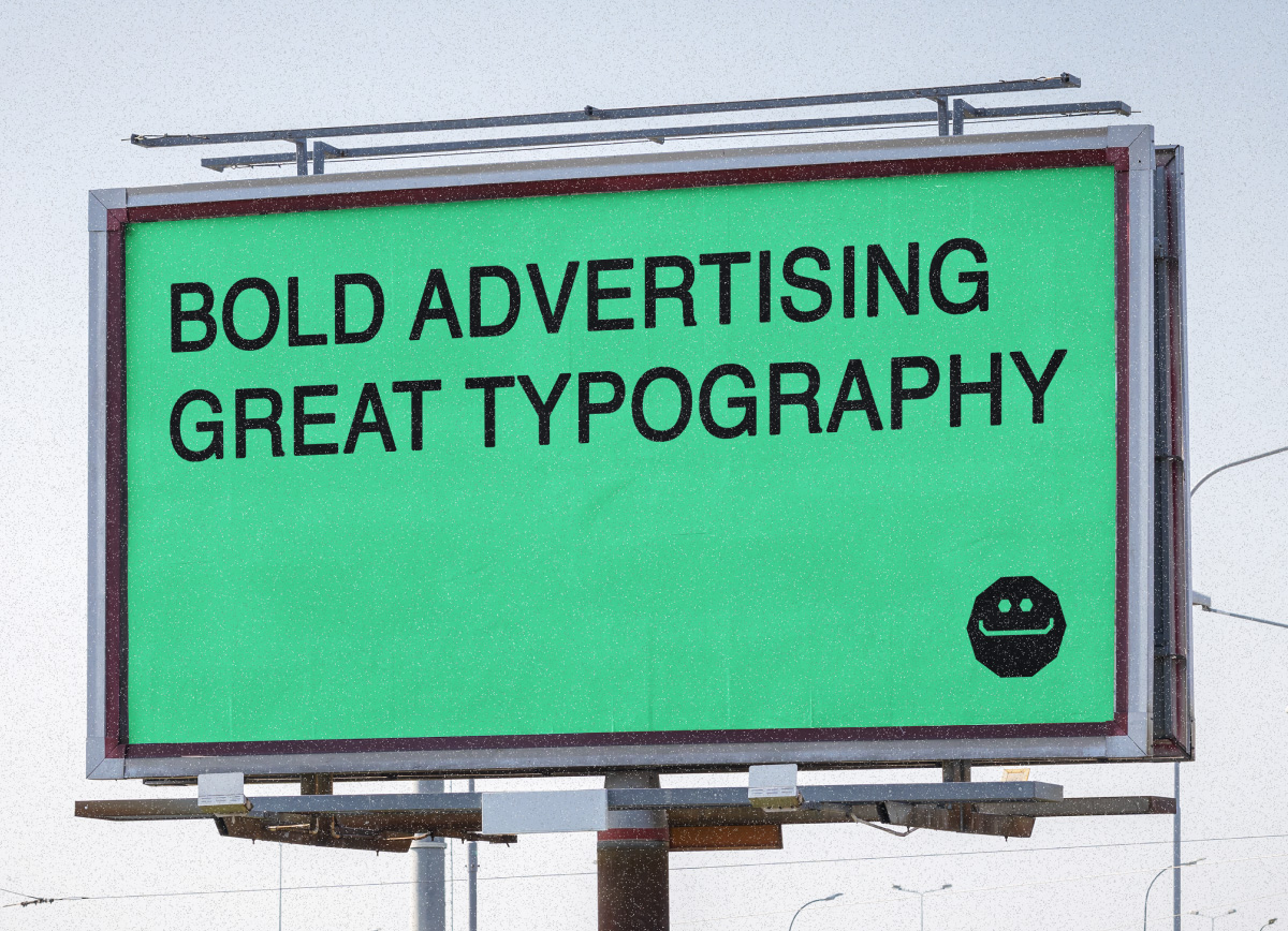 A large roadside billboard with a bright green background displays the black text "Bold Advertising, Great Typography" alongside a small smiling face logo.