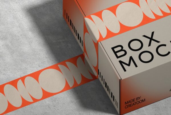 Cardboard box with "BOX MOCK" text, wrapped in orange tape with cream ovals on a concrete surface. Modern and sleek design with a creative vibe.