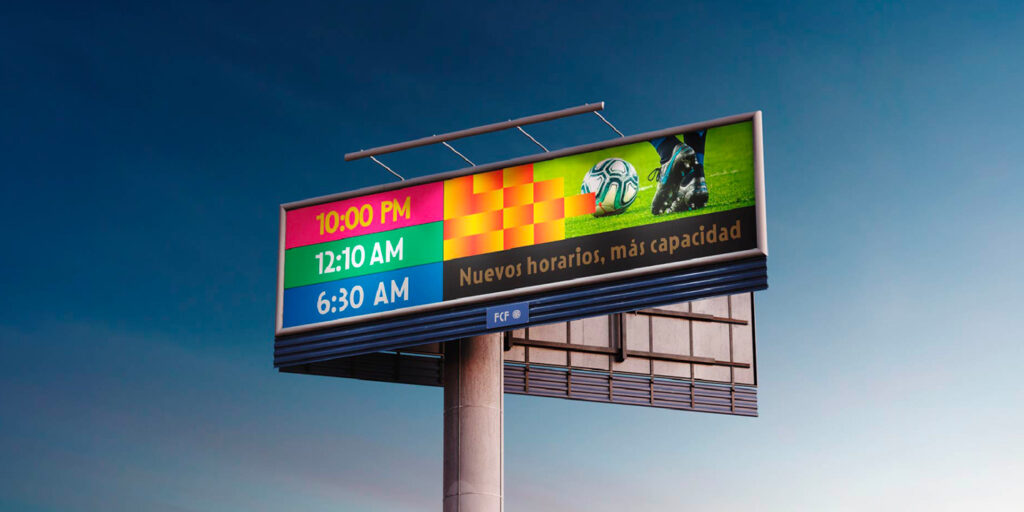 A digital billboard displays colorful schedules for events at 10:00 PM, 12:10 AM, and 6:30 AM. An image of a soccer ball and cleats is on the right, with text: "Nuevos horarios, más capacidad" against a clear sky.