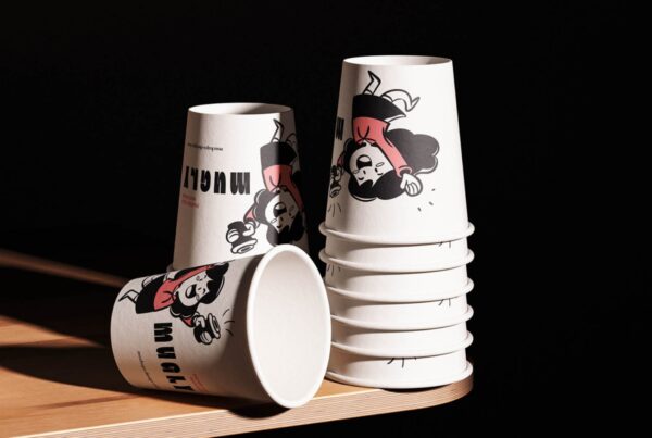 Three disposable paper cups stacked vertically against a neutral, minimalist background.