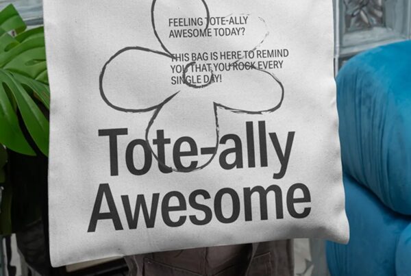 A semi-square canvas tote bag with long handles shown from a front perspective against a clean, neutral background.