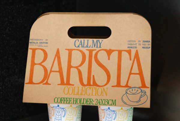A front-facing view of a brown kraft paper coffee carrier holding two illustrated cups against a dark background.