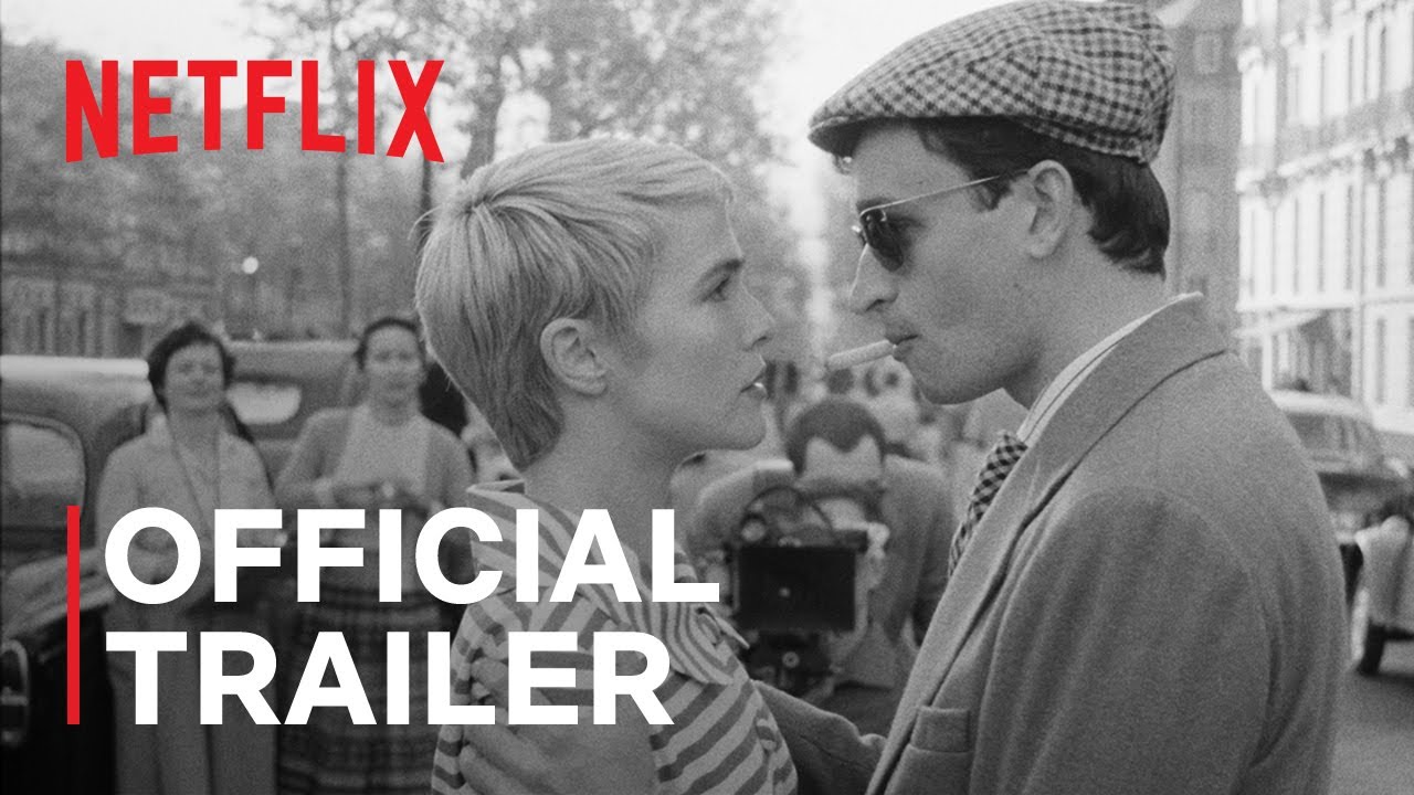 A black and white film still of a man and woman facing each other, with a Netflix logo and "Official Trailer" text.