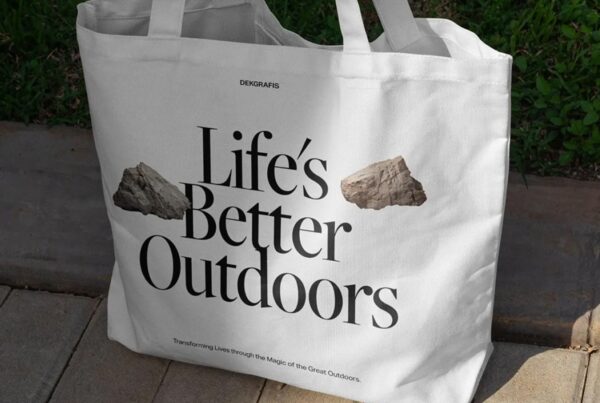 A flat-lay view of a cream-colored canvas tote bag centered against a minimal studio background.