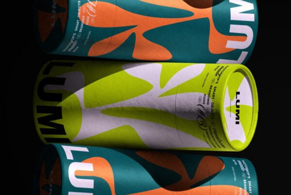 A close-up front view of three stacked cylindrical packaging tubes featuring bold, colorful abstract patterns on a solid black background.
