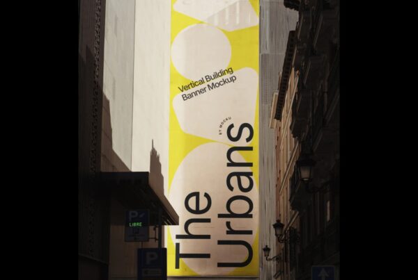 A tall, vibrant yellow outdoor advertising banner with large abstract shapes and the words "The Urbans" hanging vertically between city buildings.