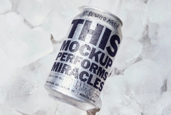A condenting aluminum beverage can with bold black typography resting on a bed of clear crushed ice cubes.