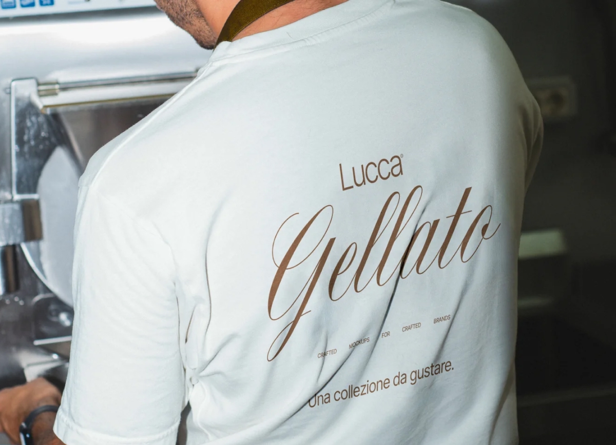 Back view of a person wearing a white t-shirt with a custom gelato brand design, working in an artisanal setting.