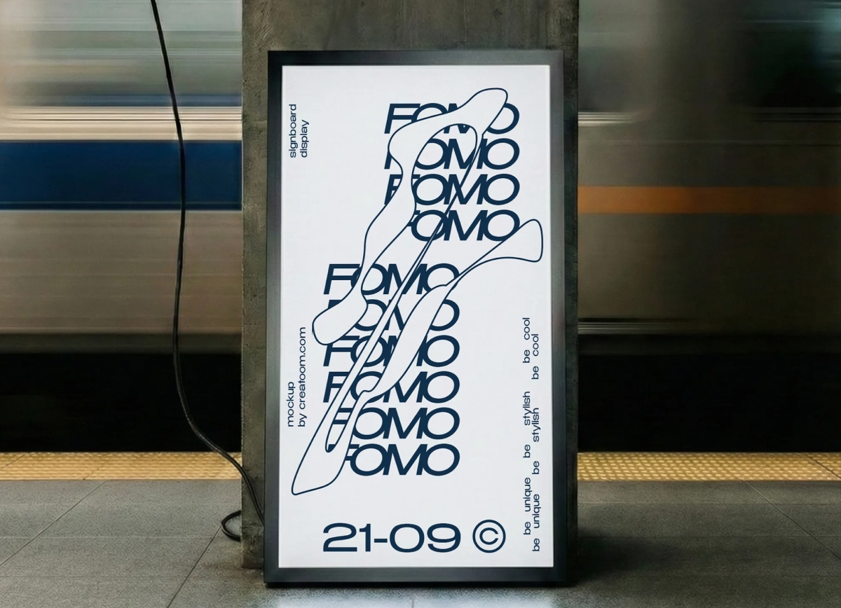 Front view of a customizable vertical display signboard standing on a tiled subway platform with a blurred train moving in the background.